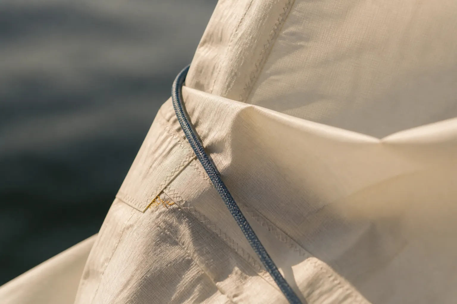 Close detail of cream sailcloth and indigo rope in warm side light