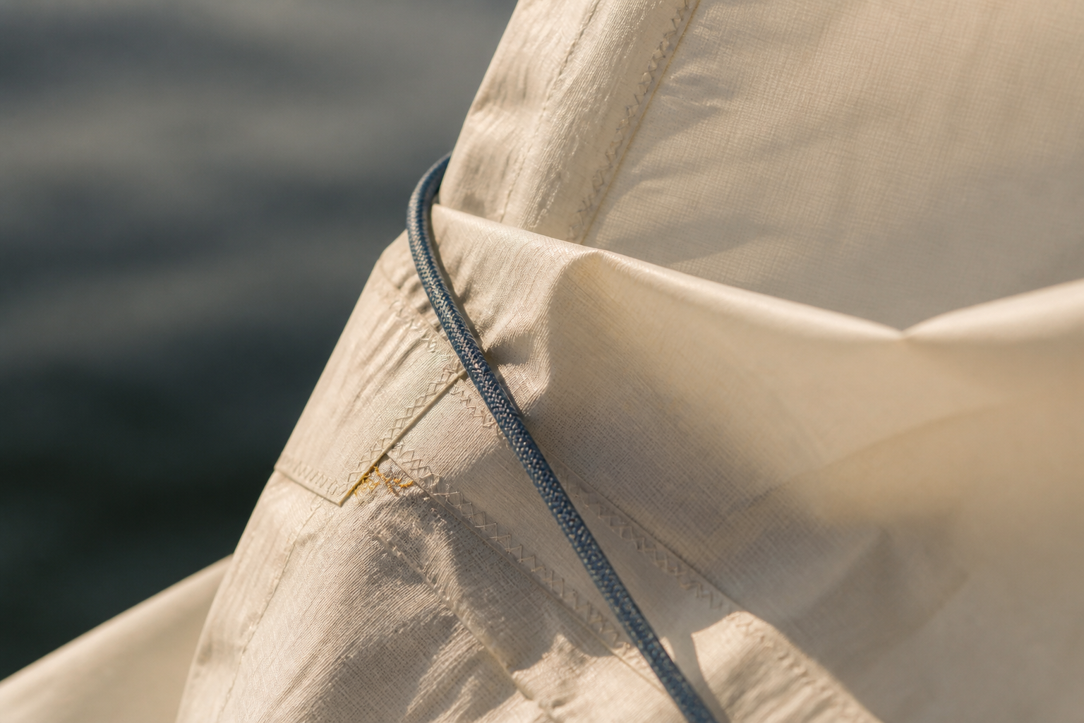 Close detail of cream sailcloth and indigo rope in warm side light